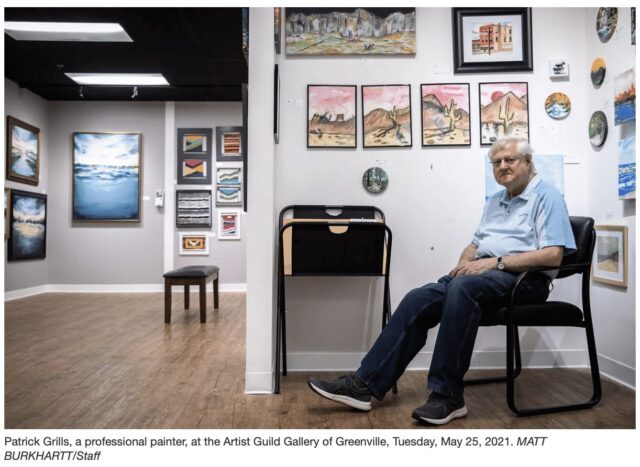 man sitting in art gallery