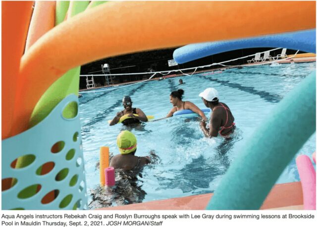 women in pool with noodles