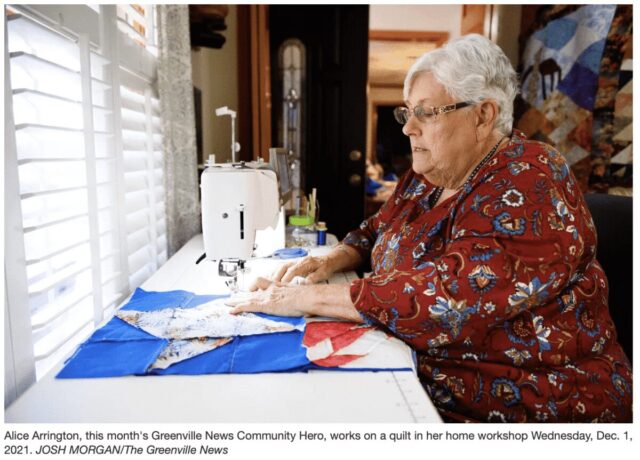 woman at sewing machine in red shirt