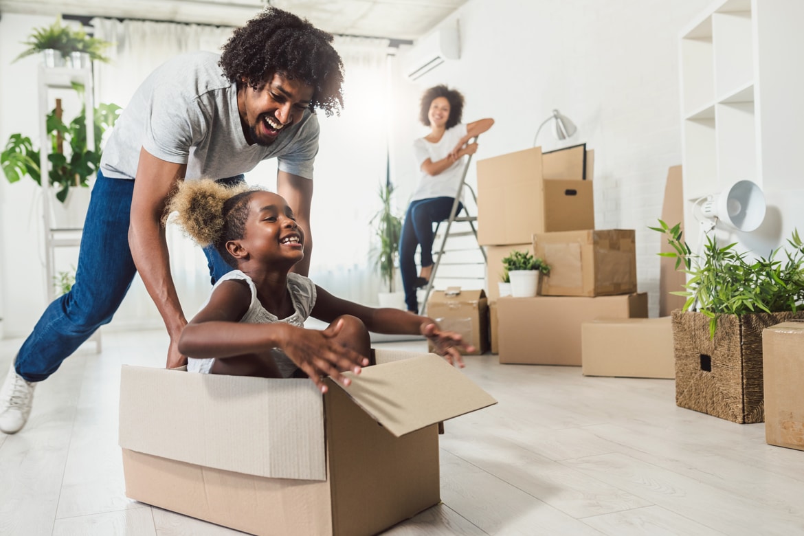 Family enjoying moving day with boxes; personal loans offer lower rates, fixed payments for such uncommon uses.