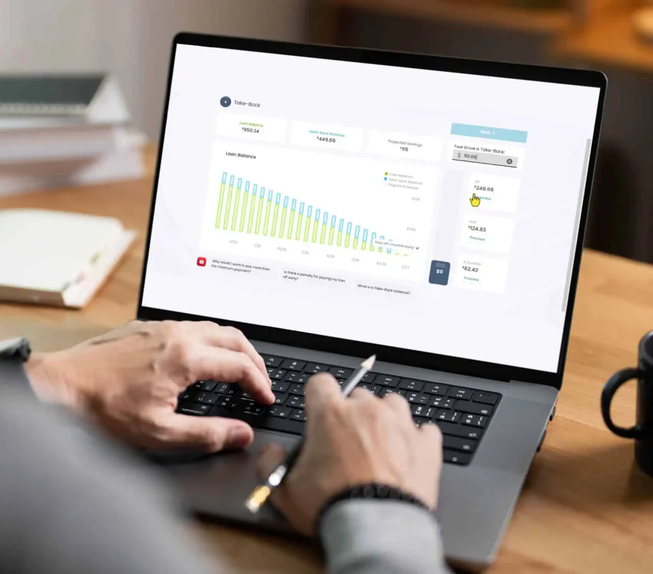 Person working on a laptop displaying Greenville Federal Credit Union’s Take-Back® Loan dashboard.