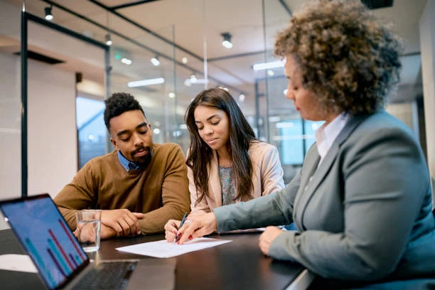 Couple consulting with a financial advisor about tailored personal loans for life events and debt consolidation.