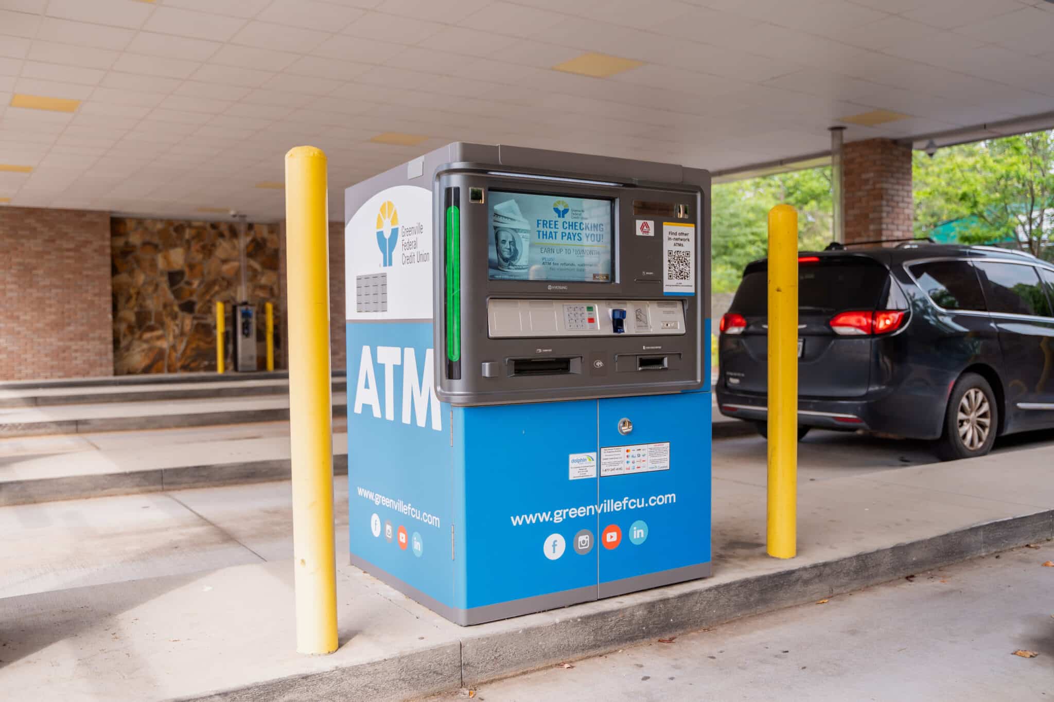 Greenville Federal Credit Union ATM offering free checking located in a covered drive-thru area.