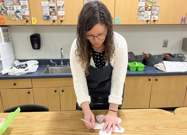 teacher demonstrating a tracing technique