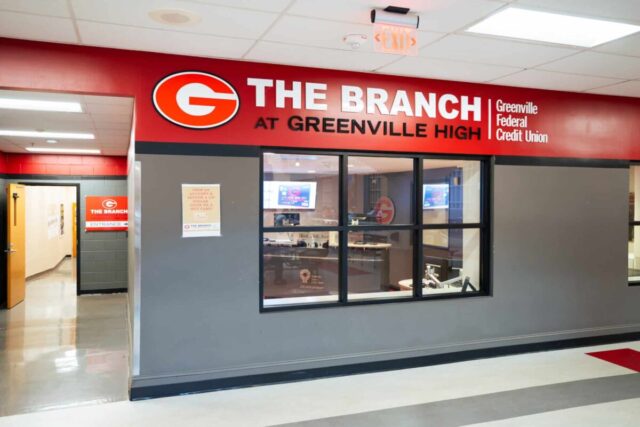 The Branch at Greenville High entrance with bold red signage, offering hands-on banking experience.