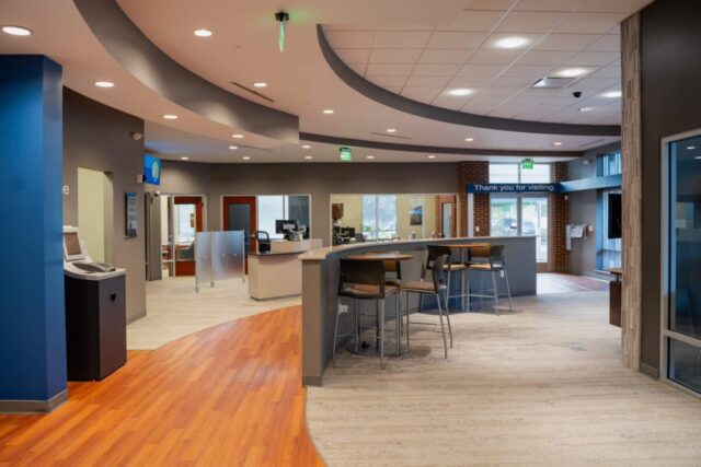 Modern credit union lobby with sleek counters and seating, emphasizing a personal, core values experience.