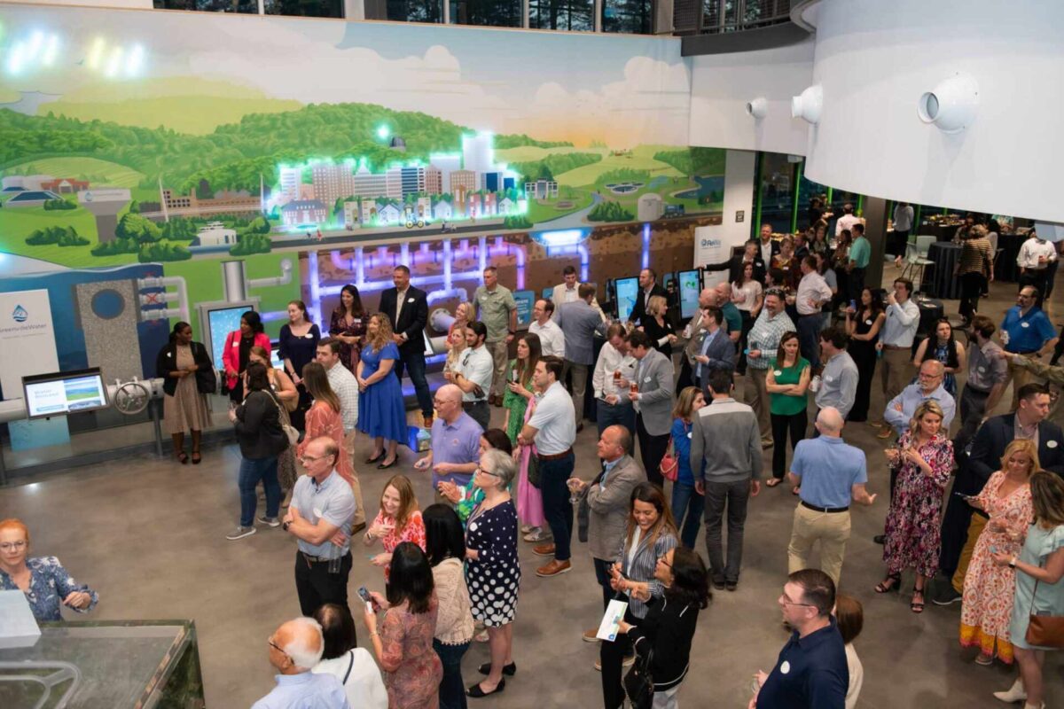 Crowd gathered at an indoor Greenville event, supporting local education with Greenville Federal Credit Union initiatives.