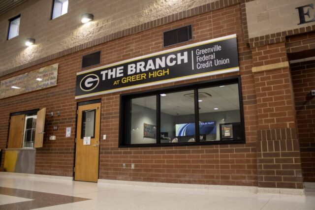 Greer High's student banking branch with "The Branch at Greer High" sign, enhancing financial skills.