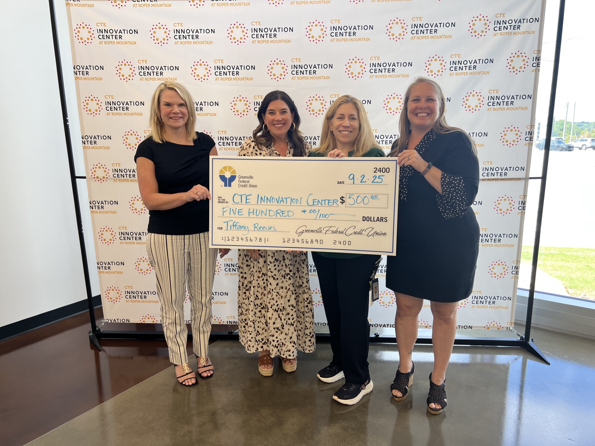 Tiffany Reeves receiving a $500 grant check from Greenville Federal Credit Union Foundation at CTE Innovation Center.