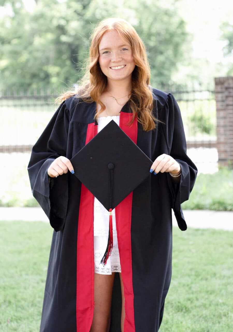 Graduate in cap and gown from Anderson University, supported by Greenville Federal Credit Union Foundation grants.