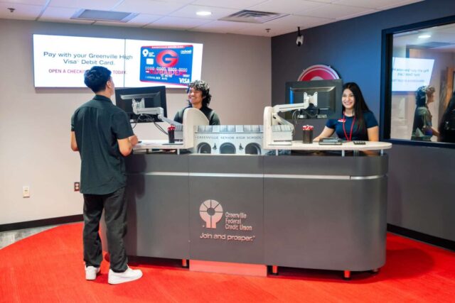 Students engaging in hands-on banking at Greenville High's branch, enhancing financial experience.