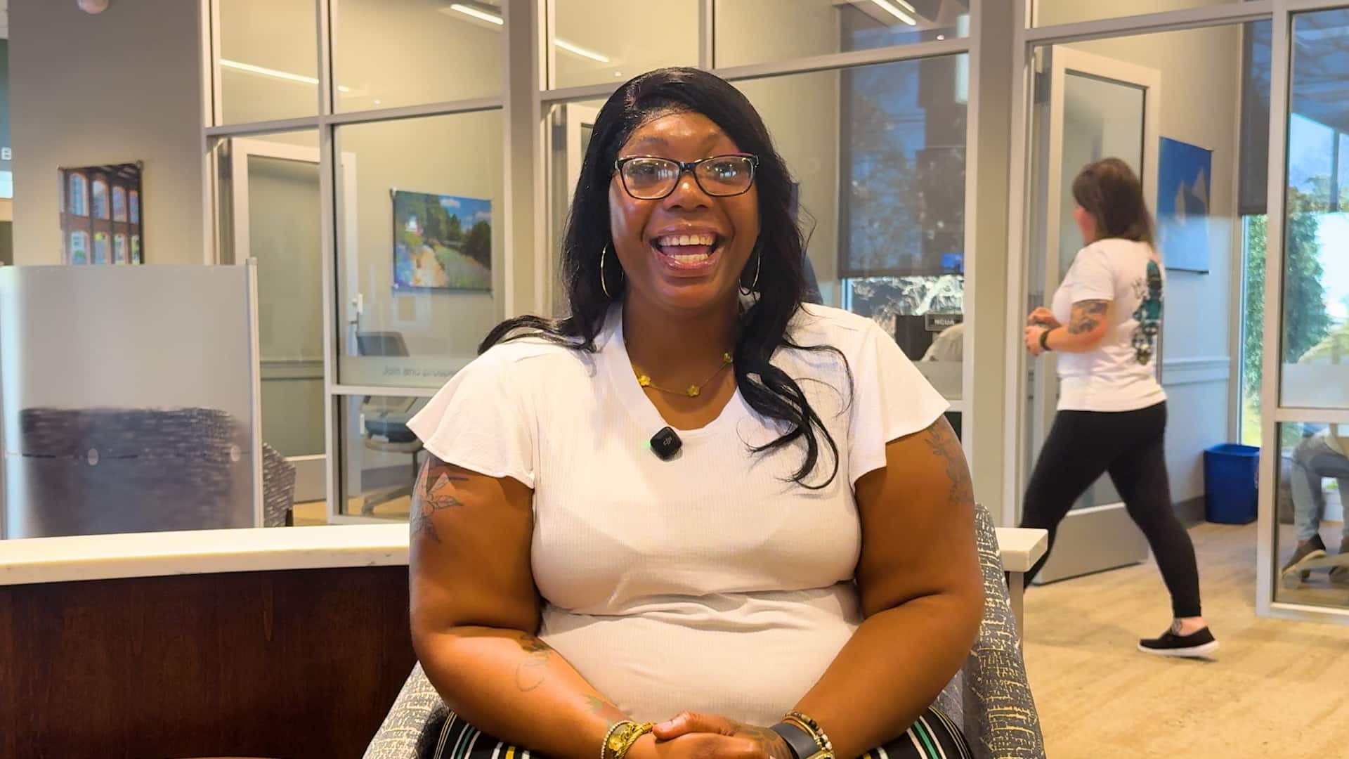 woman sitting in the Greenville Federal Credit Union lobby.
