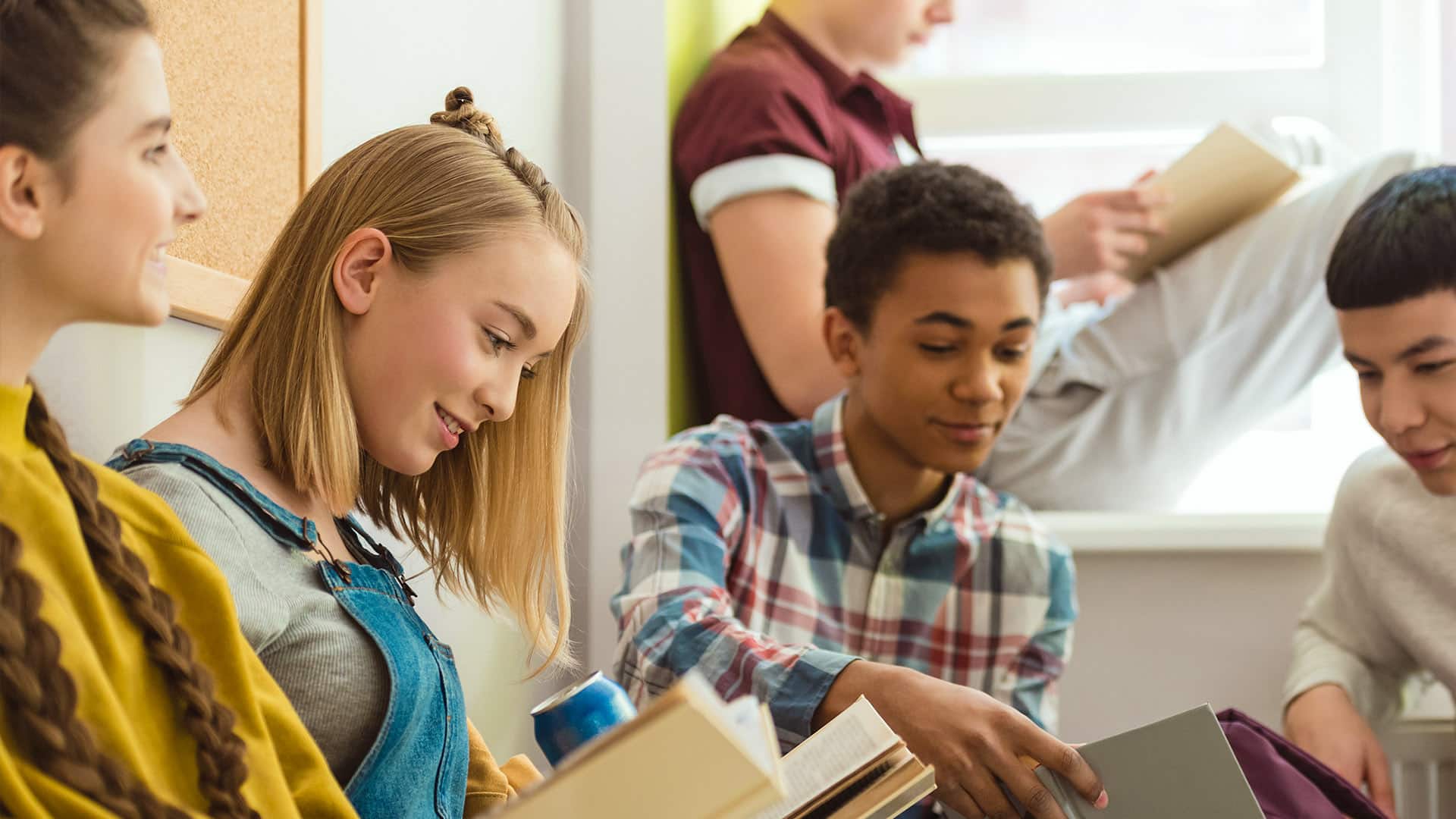 Multicultural high school students collaborating on homework, highlighting tailored resources and exclusive Greenville program rewards.