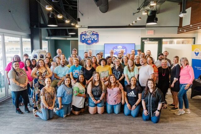A group of employees casually posing together.