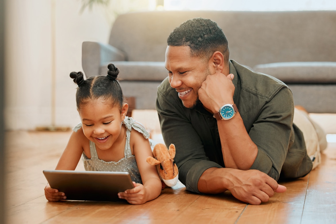 Cybersecurity for Kids - A Parents Guide father and daughter looking and smiling at tablet