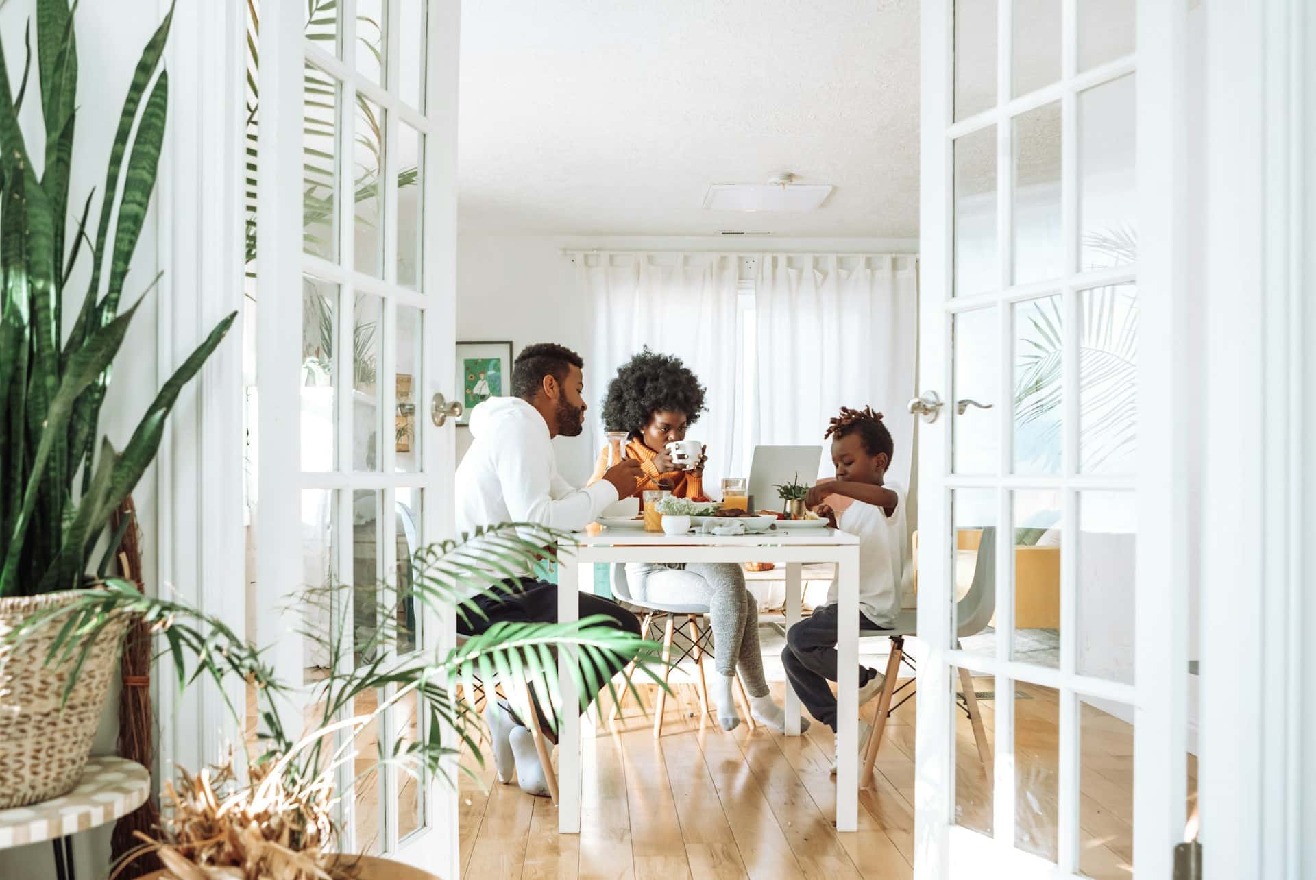 family eating at a well lit table in their house